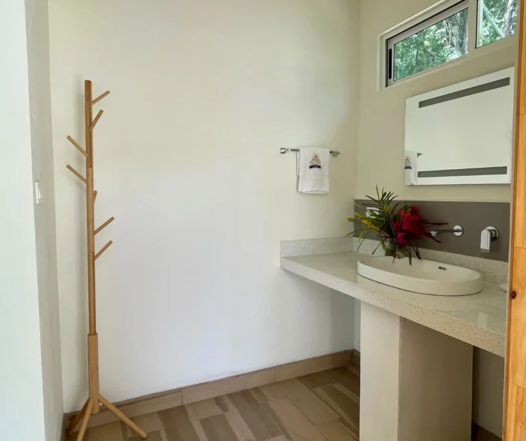 Modern bathroom of the deluxe room at Casa Sollevante with minimalist design and natural light.