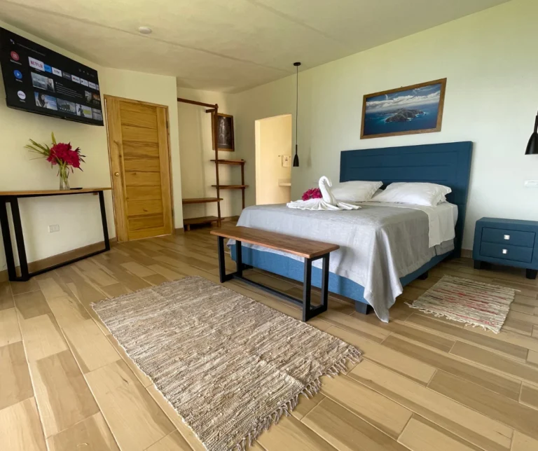 Deluxe room bedroom with king bed, panoramic views and contemporary decor at Casa Sollevante Montezuma.