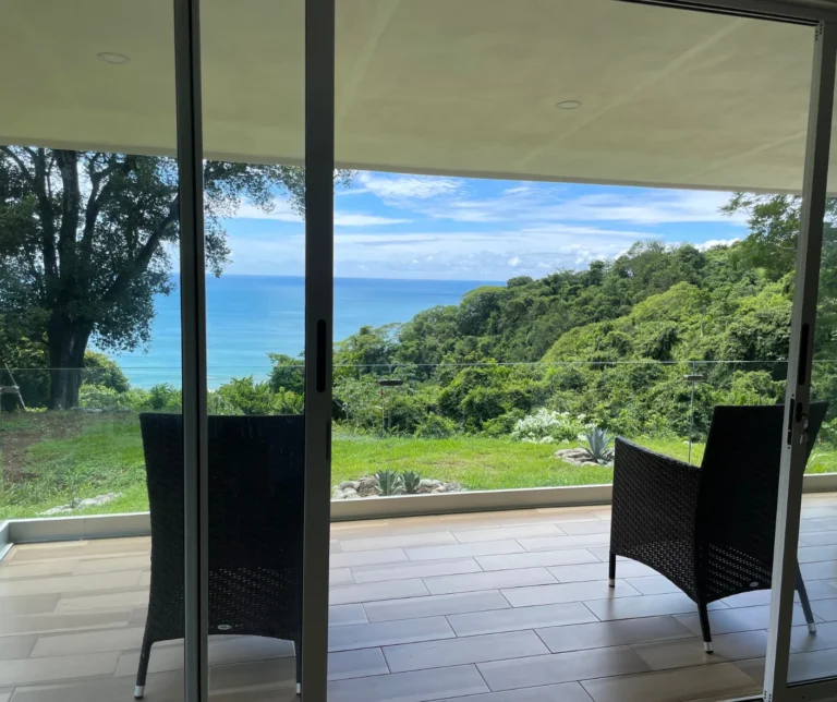 Private terrace of the deluxe room at Casa Sollevante overlooking the Pacific Ocean and tropical rainforest in Montezuma.