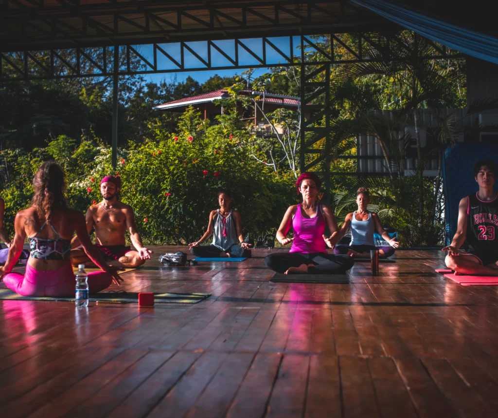 Morning Devaya Yoga class at Casa Sollevante in Montezuma, Costa Rica — Blue Zone wellness retreat with ocean-view platform.