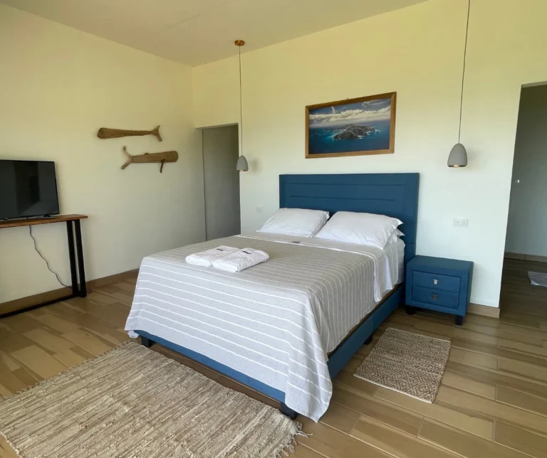 Bright interior of the Junior Suite bedroom at Casas Sollevante, designed for comfort during Costa Rica yoga retreats.