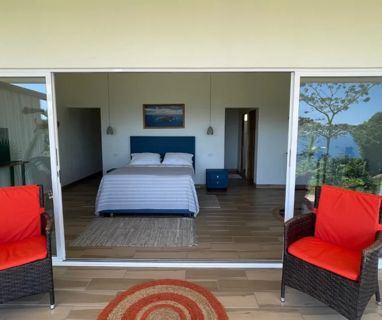 Junior Suite with ocean-view sliding doors and private terrace at Casas Sollevante in Montezuma, ideal for luxury yoga retreats.